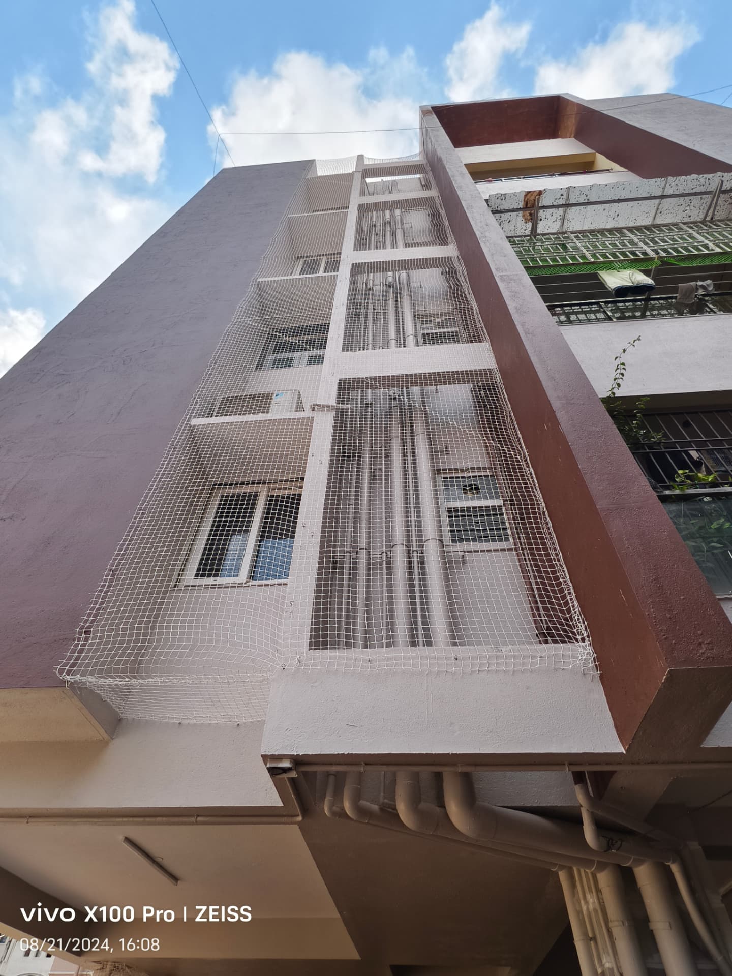 Pigeon net covering a multi-storey exterior opening — general real YPL pigeon-net work in Chennai, property not identified