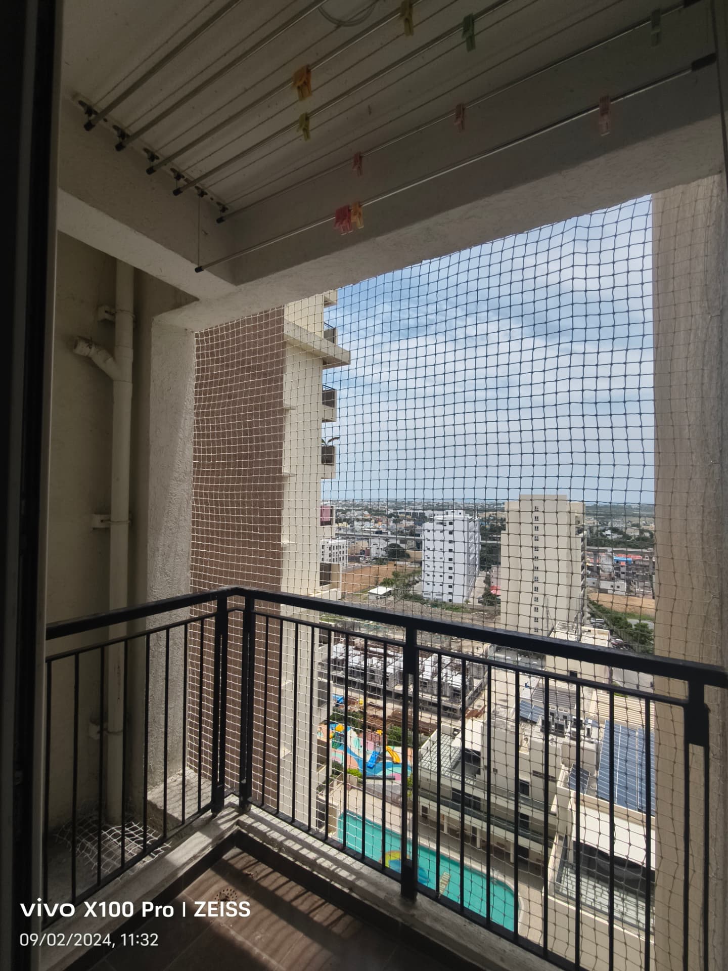 Pigeon net across a high-rise balcony opening — general real YPL pigeon-net work in Chennai, property not identified