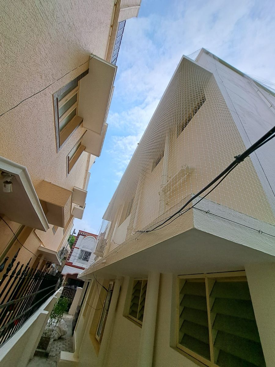 Bird nets covering a Chennai house wall and AC outdoor unit, installed by YPL Safety Nets